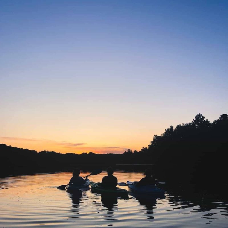 People canoeing at sunset.