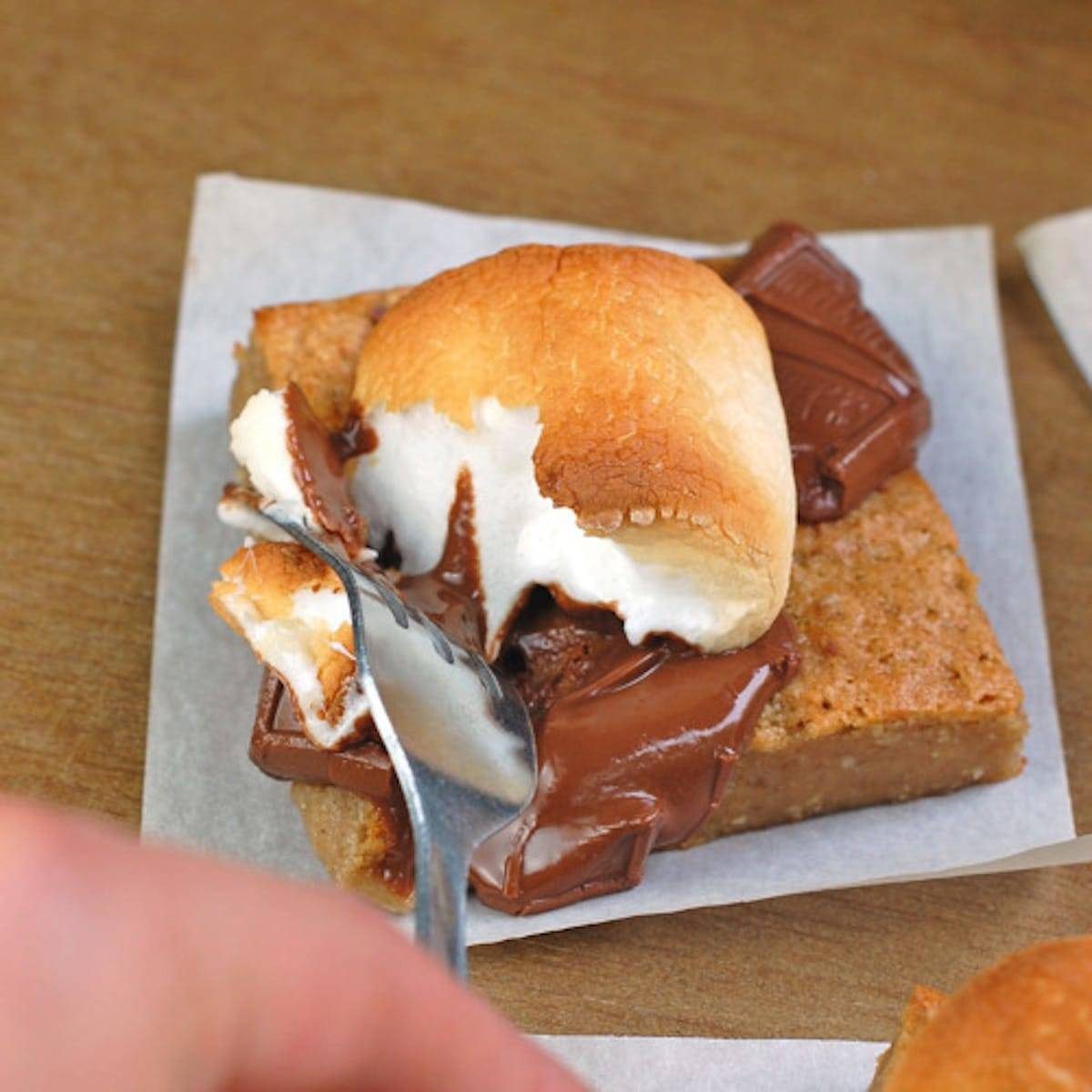 Graham bars topped with melted chocolate and fluffy marshmallows.