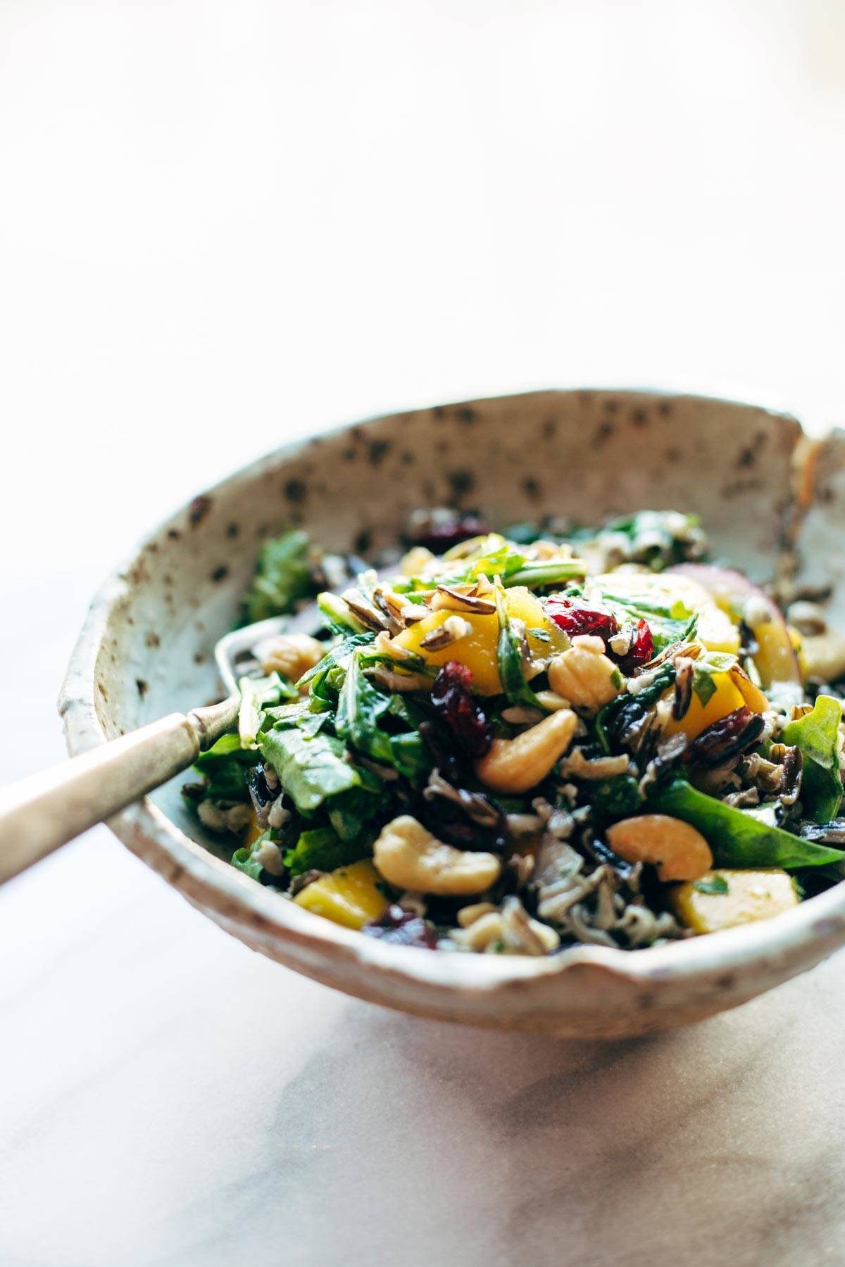 Easy Thanksgiving Salad - arugula, wild rice, cashews, dried cranberries, red onions, and a lemon dressing that shakes up easily in a jar. | pinchofyum.com Easy Thanksgiving Salad - arugula, wild rice, cashews, dried cranberries, red onions, and a lemon dressing that shakes up easily in a jar. | pinchofyum.com